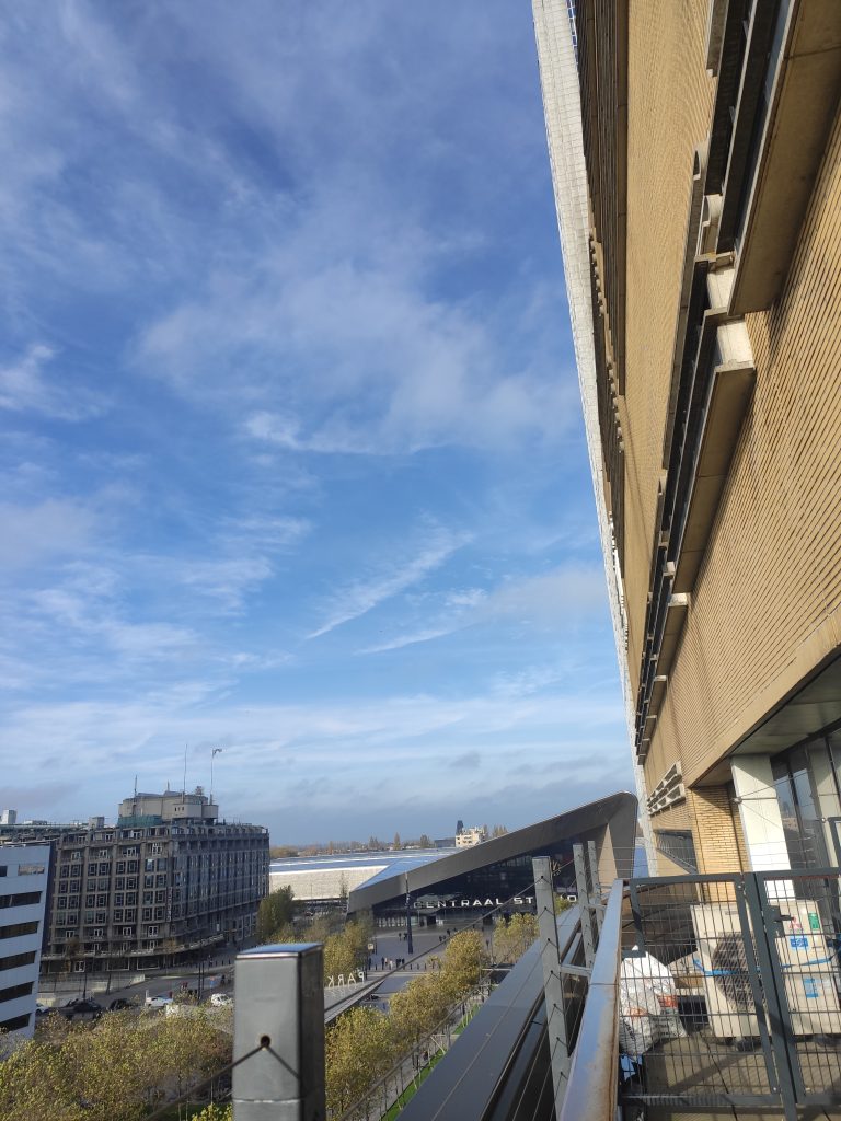 Panorama miasta widziana z balkonu, widok na dworzec i rzekę.